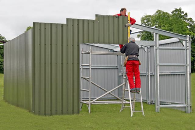 Two men constructing a green building