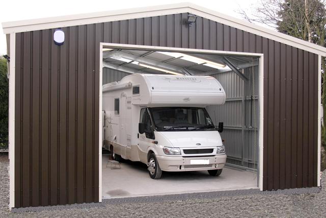 A brown building containing a large motorhome
